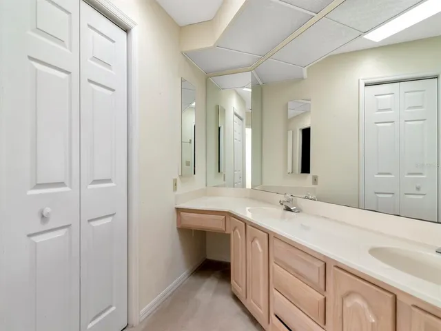 a bathroom with a double vanity sink and mirror