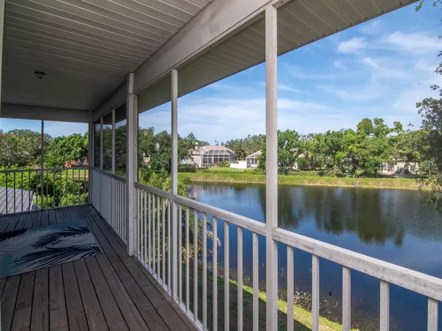 a view of a balcony with lake view and wooden floor