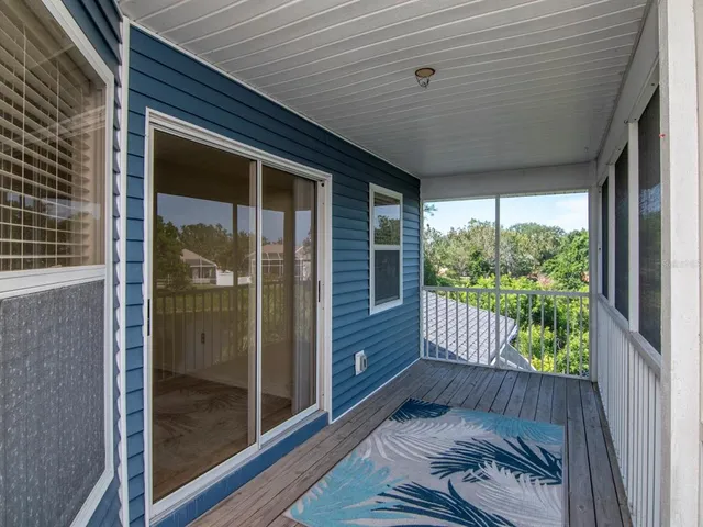 a view of a balcony with floor to ceiling window with wooden floor