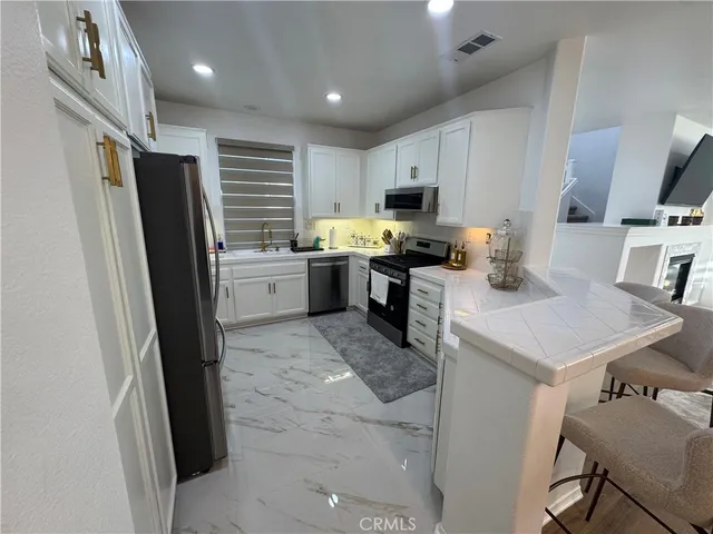 a kitchen with refrigerator and cabinets