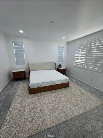 a bedroom with a bed a table and chair