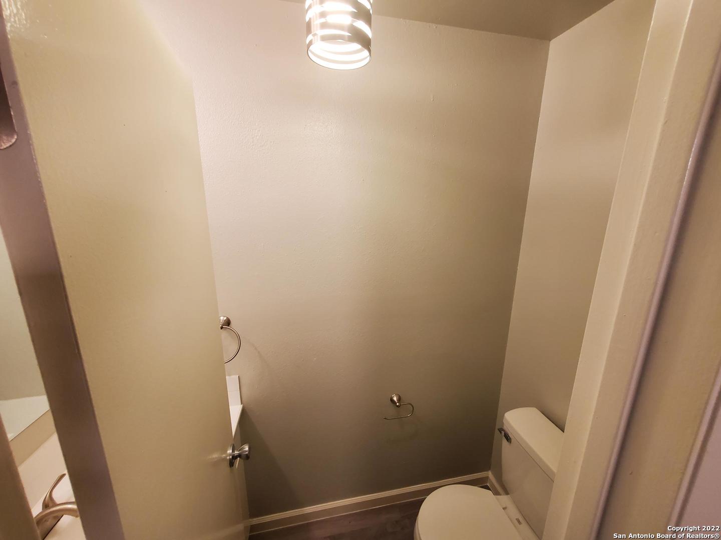 911 Y Vance Jackson Road San Antonio, TX 78201 - Photo 11 of 18 a bathroom with a sink and toilet