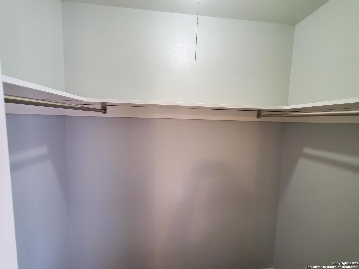 911 Y Vance Jackson Road San Antonio, TX 78201 - Photo 15 of 18 a view of a closet with racks on the wall