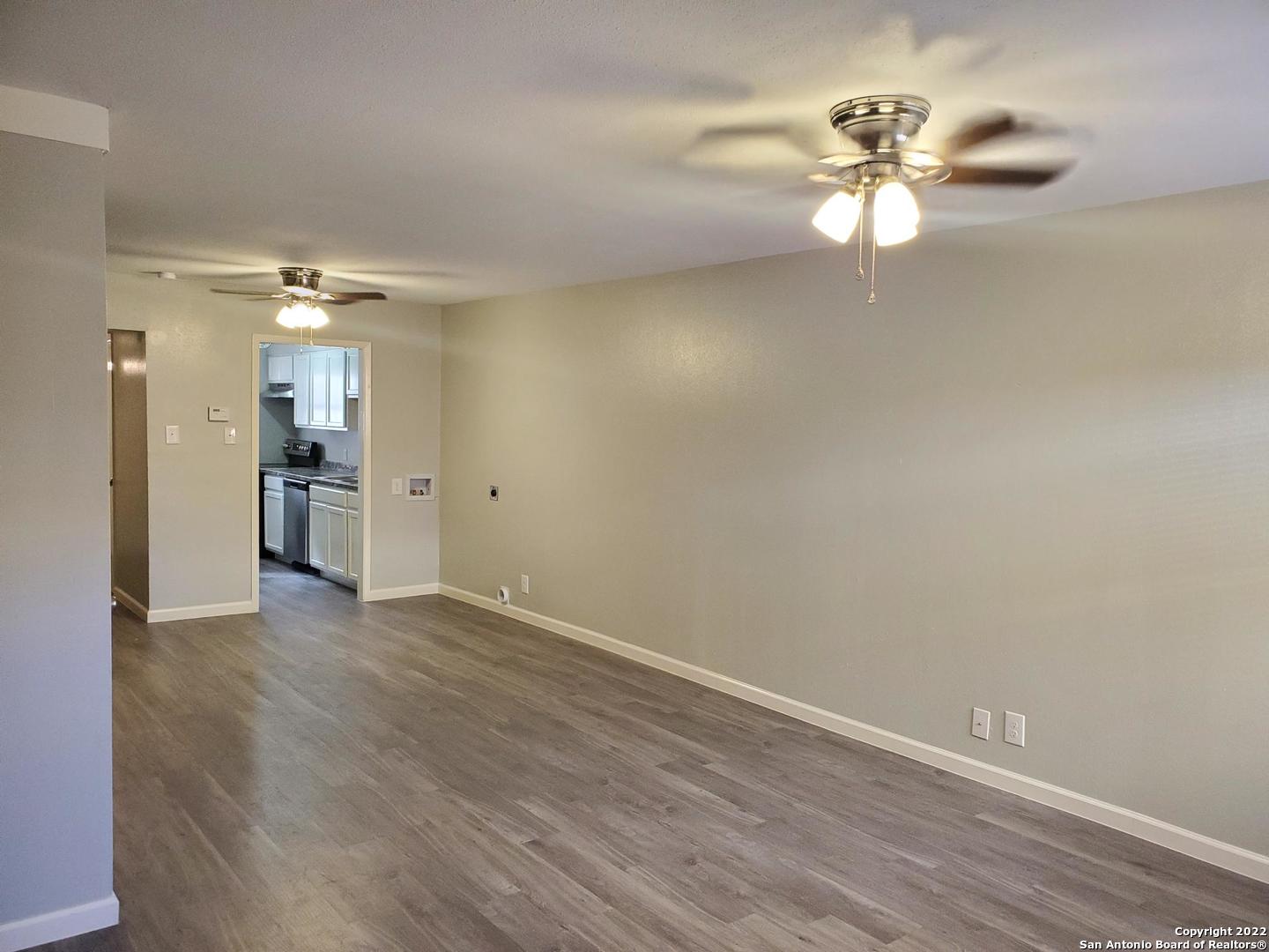 911 Y Vance Jackson Road San Antonio, TX 78201 - Photo 3 of 18 wooden floor in an empty room with a window