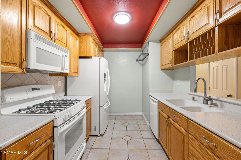 2044 Covington Avenue Simi Valley, CA 93065 - Photo 13 of 32 a kitchen with stainless steel appliances a stove a sink and a refrigerator