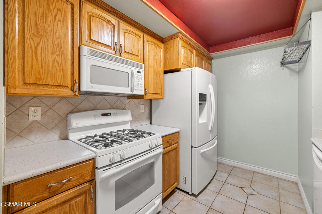 2044 Covington Avenue Simi Valley, CA 93065 - Photo 15 of 32 a kitchen with white cabinets and white appliances