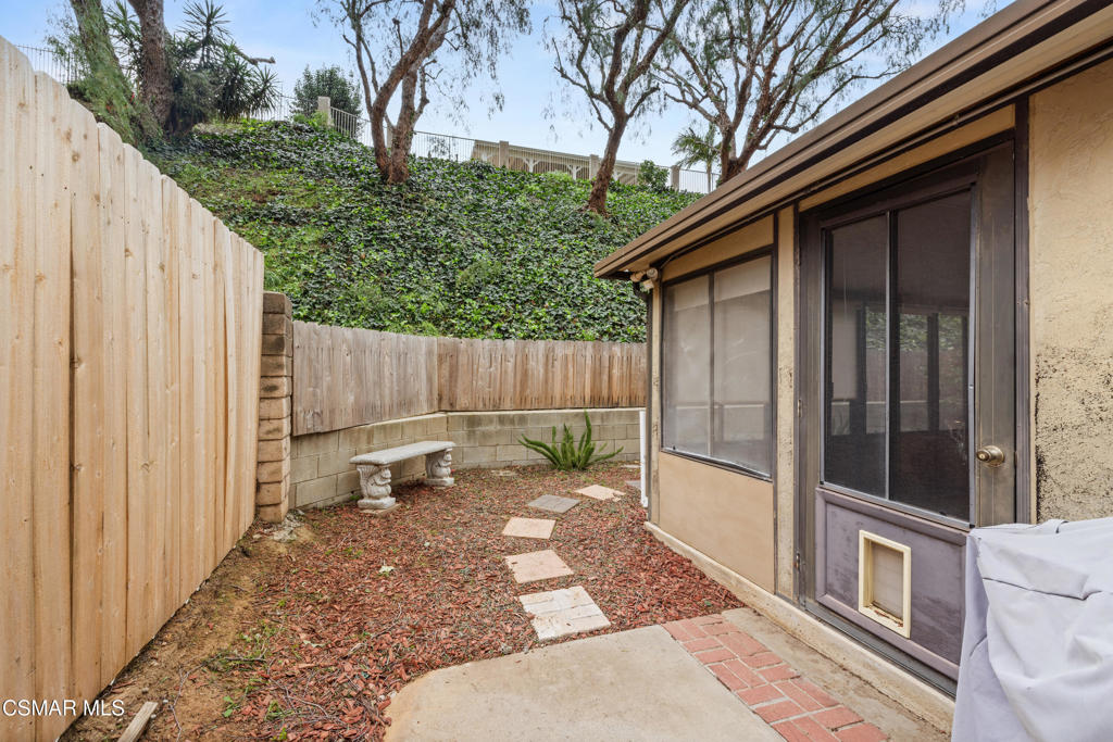 2044 Covington Avenue Simi Valley, CA 93065 - Photo 26 of 32 a view of a backyard with a large tree and wooden fence