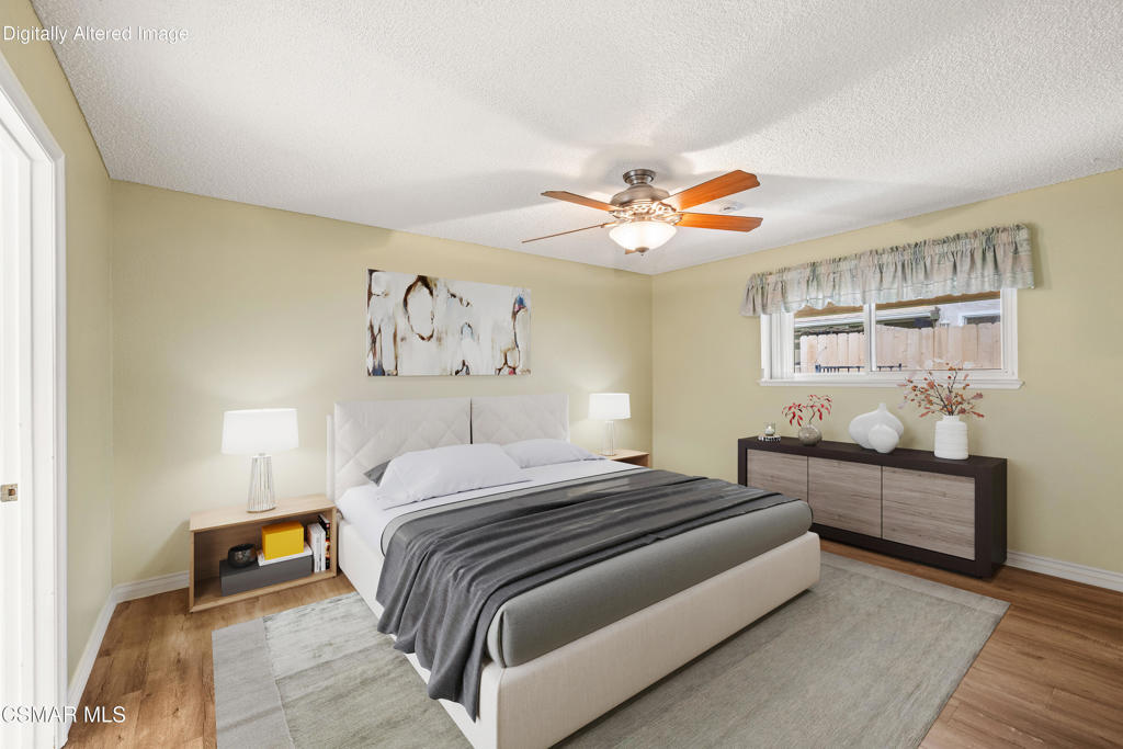 2044 Covington Avenue Simi Valley, CA 93065 - Photo 5 of 32 a bedroom with a bed and a chandelier