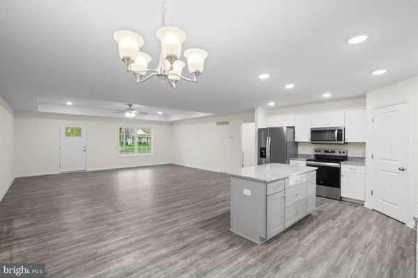 a view of kitchen with cabinets and wooden floor