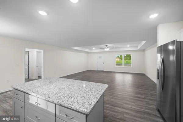 an empty room with wooden floor and window