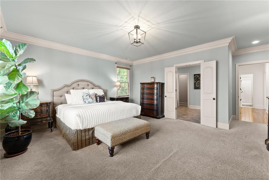 4529 Montclair Circle Gainesville, GA 30506 - Photo 11 of 34 a spacious bedroom with a bed and a potted plant