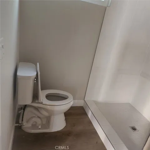 a white toilet sitting next to a bath tub