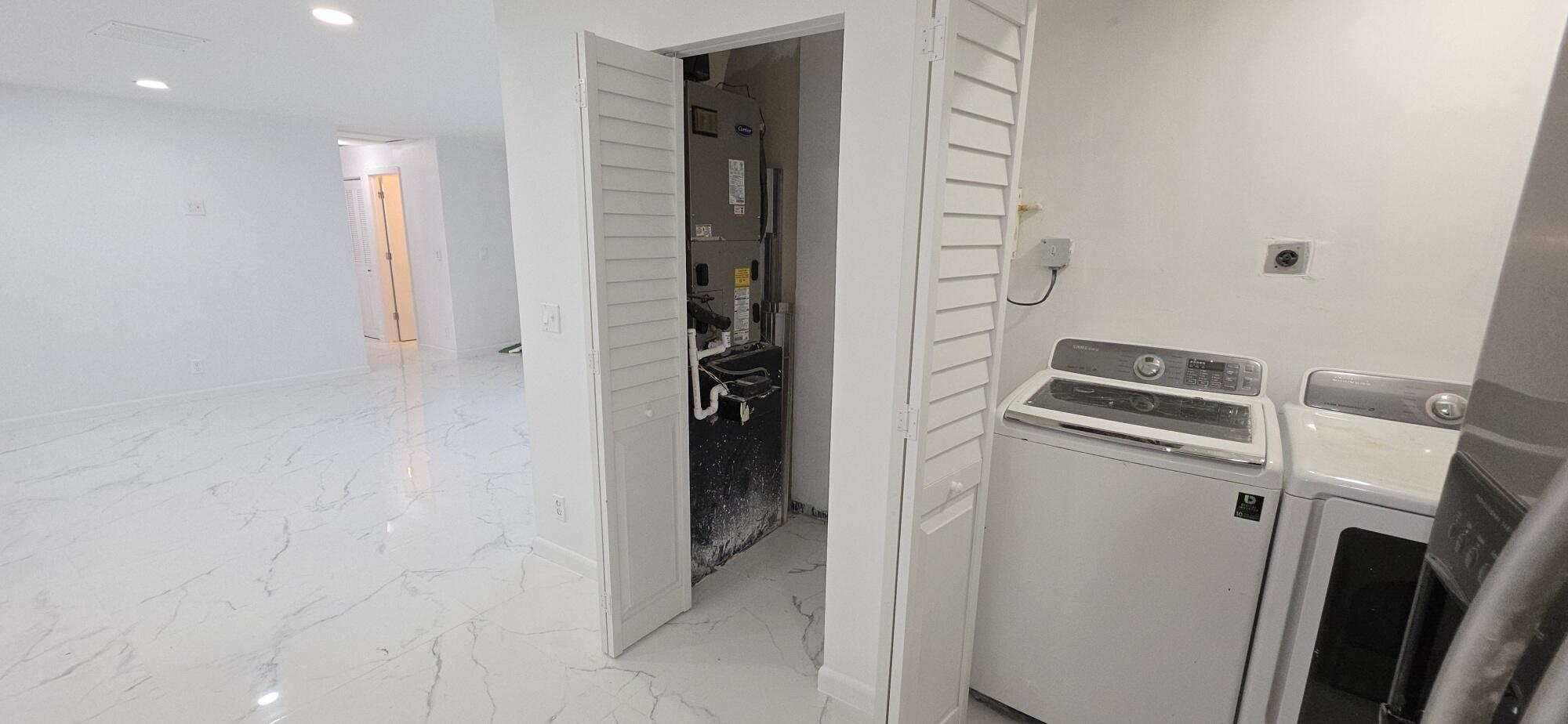 7112 Pine Manor Drive Lake Worth, FL 33467 - Photo 23 of 32 a bathroom with a sink and a mirror