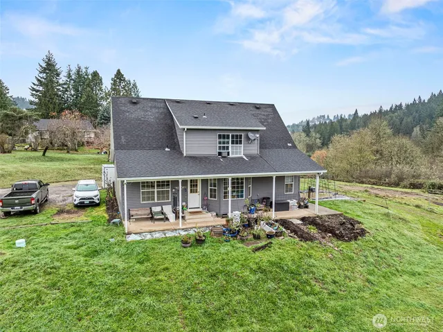 a view of a house with backyard porch and garden