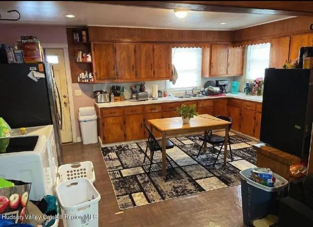 a kitchen with stainless steel appliances granite countertop a refrigerator and a stove top oven