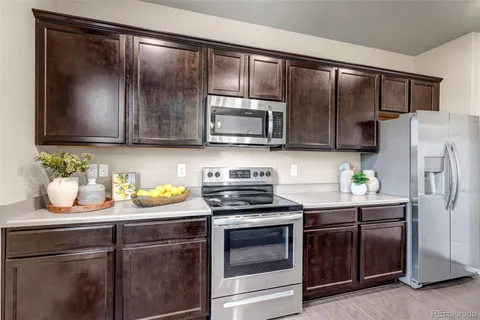 a kitchen with a refrigerator stove and microwave