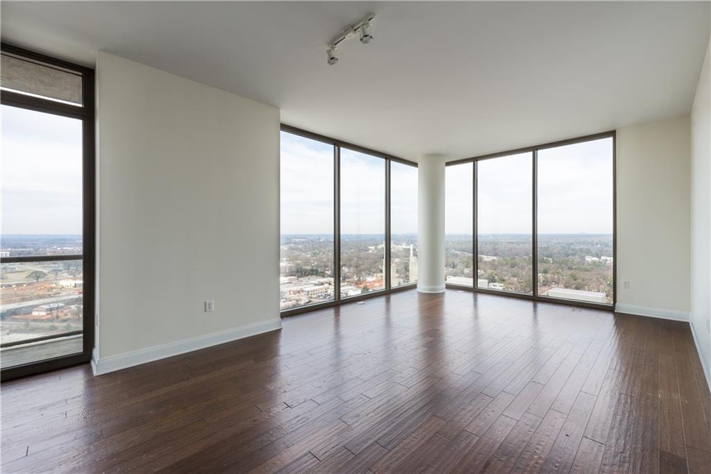 270 17th Street Northwest, Unit 3110 Atlanta, GA 30363 - Photo 3 of 23 a view of an empty room window and wooden floor