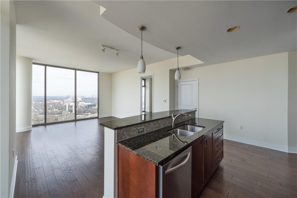 270 17th Street Northwest, Unit 3110 Atlanta, GA 30363 - Photo 8 of 23 a bathroom with a granite countertop sink and a large mirror