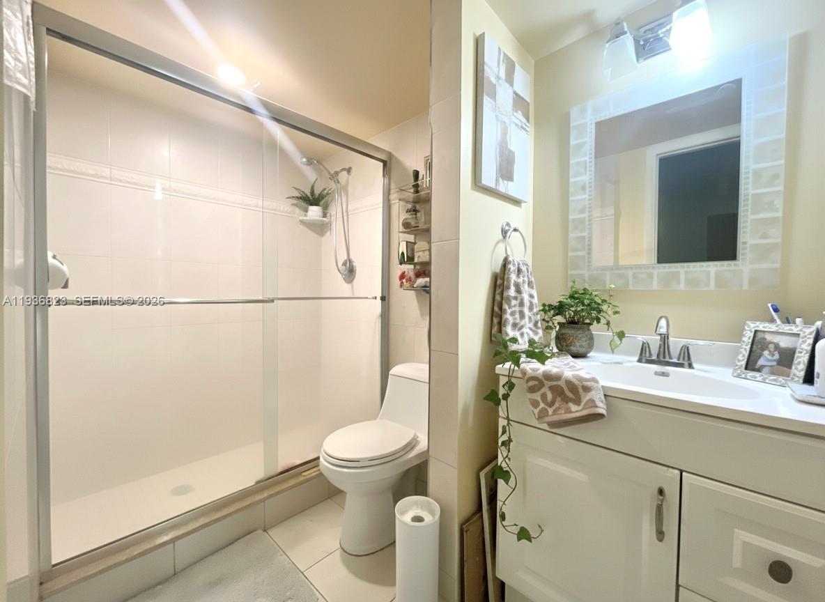 636 Northwest 13th Street, Unit 230 Boca Raton, FL 33486 - Photo 11 of 25 a bathroom with a granite countertop sink mirror vanity and toilet