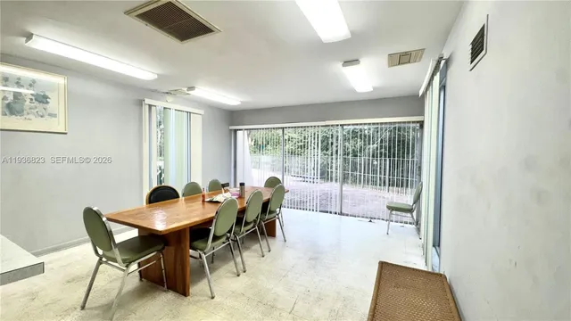 a view of a dining room with furniture and a potted plant