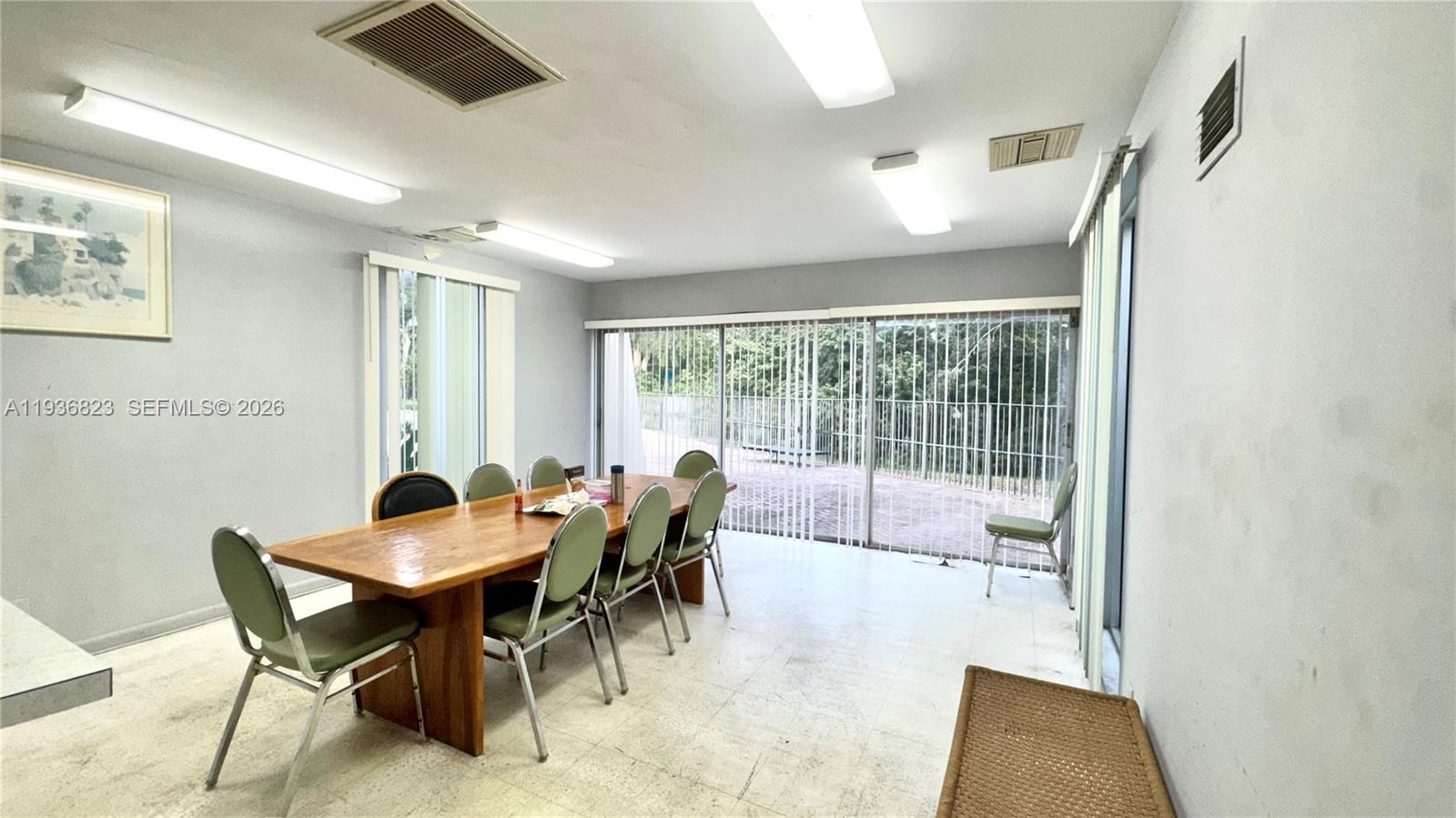 636 Northwest 13th Street, Unit 230 Boca Raton, FL 33486 - Photo 23 of 25 a view of a dining room with furniture and a potted plant