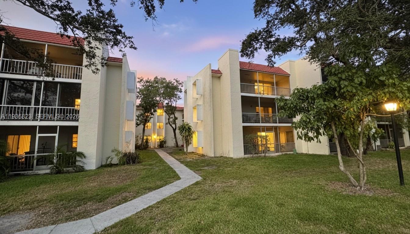 636 Northwest 13th Street, Unit 230 Boca Raton, FL 33486 - Photo 5 of 25 a front view of a house with a yard