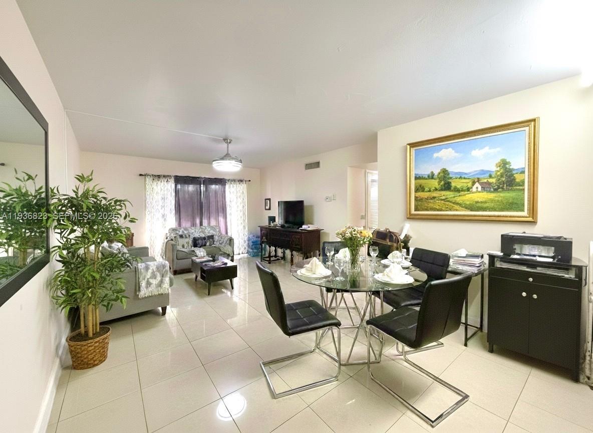 636 Northwest 13th Street, Unit 230 Boca Raton, FL 33486 - Photo 6 of 25 a living room with furniture and a potted plant