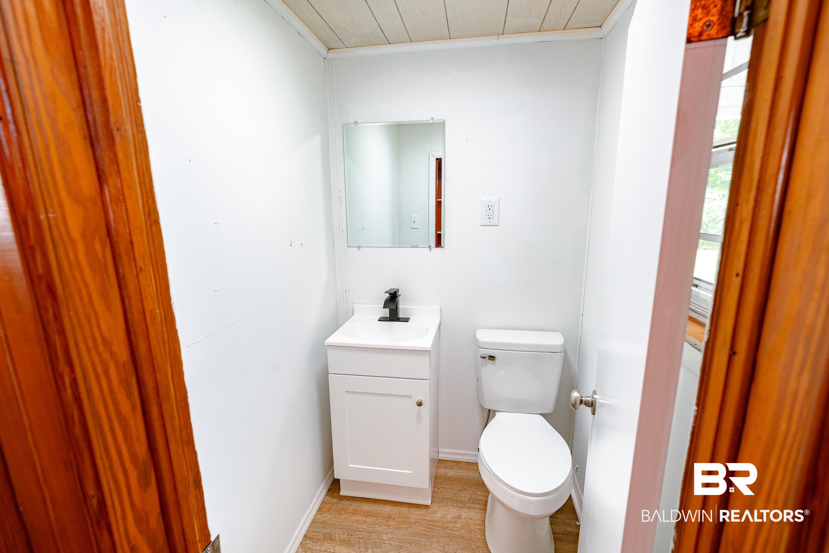 1160 Military Road Mount Vernon, AL 36560 - Photo 21 of 30 Bathroom featuring vanity, toilet, crown molding, and hardwood / wood-style floors