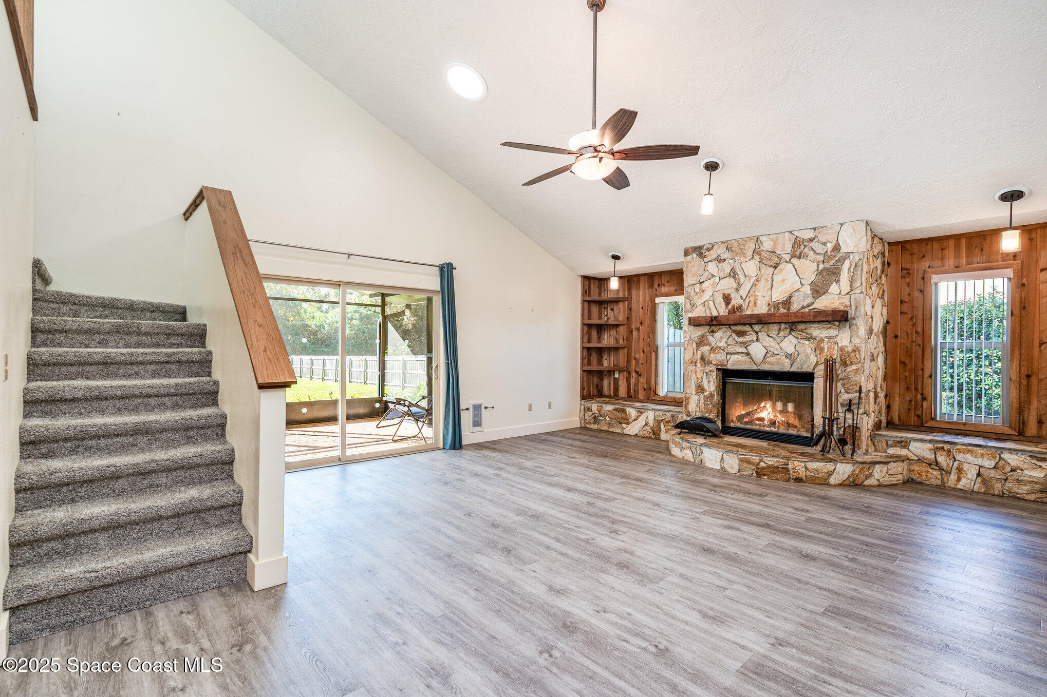 2515 Fairfield Drive Cocoa, FL 32926 - Photo 11 of 31 a view of a livingroom with wooden floor a fireplace and window