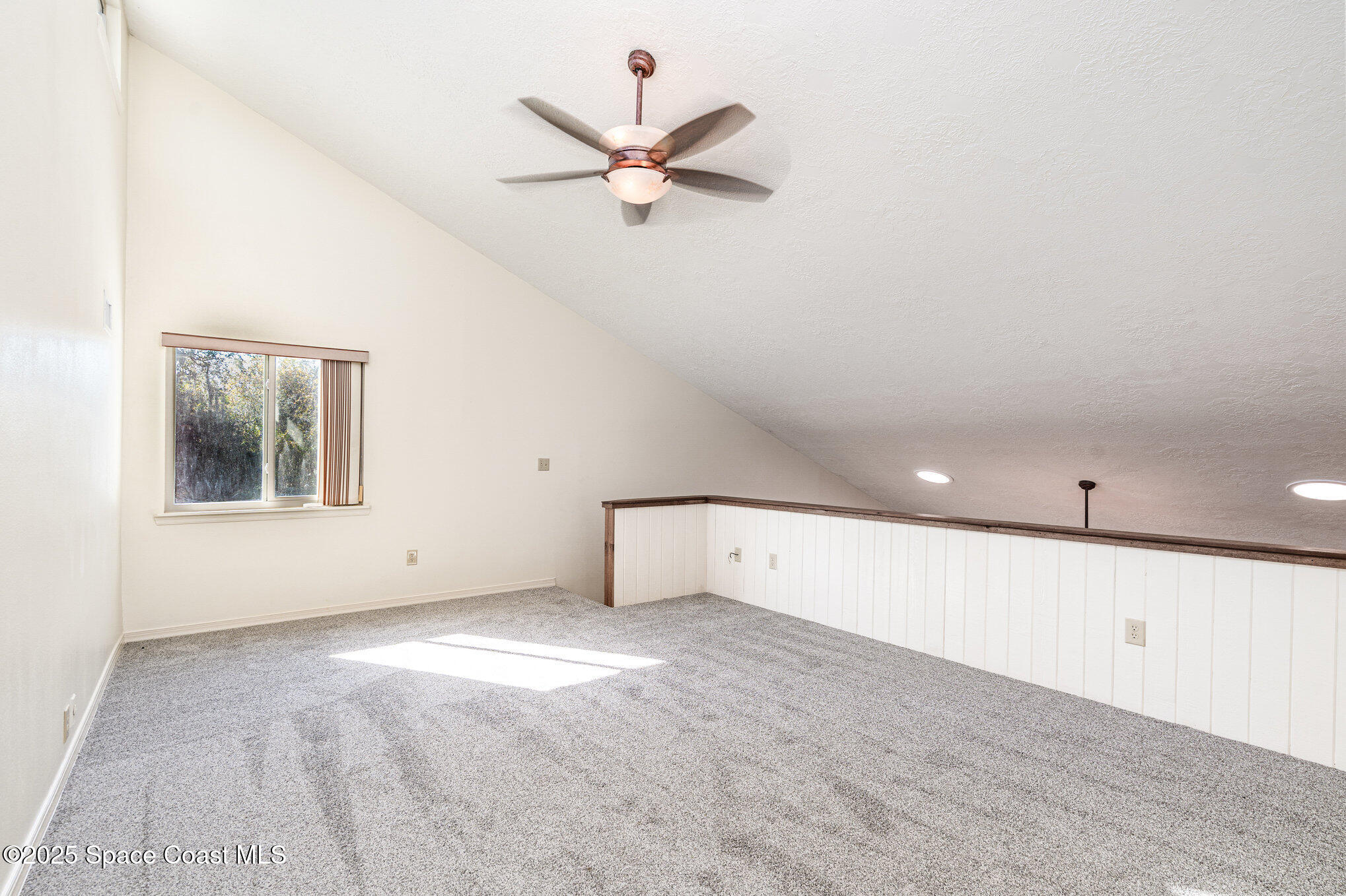 2515 Fairfield Drive Cocoa, FL 32926 - Photo 12 of 31 an empty room with windows and ceiling fan