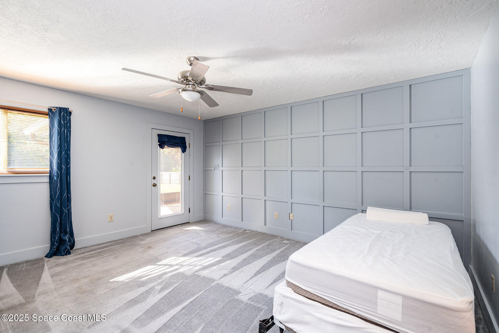 2515 Fairfield Drive Cocoa, FL 32926 - Photo 14 of 31 a bedroom with a bed and a ceiling fan