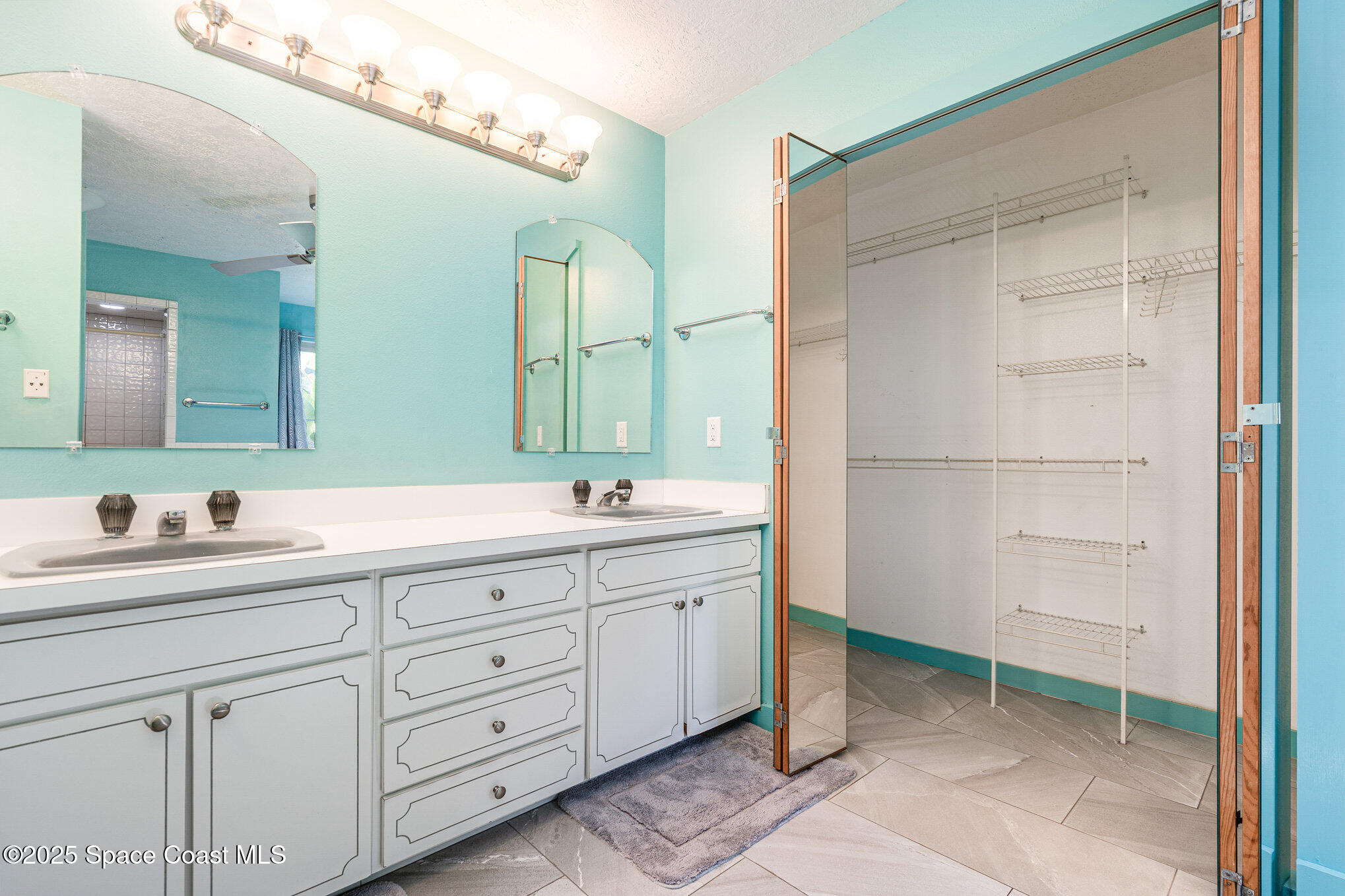 2515 Fairfield Drive Cocoa, FL 32926 - Photo 15 of 31 a spacious bathroom with a double vanity sink a mirror and a