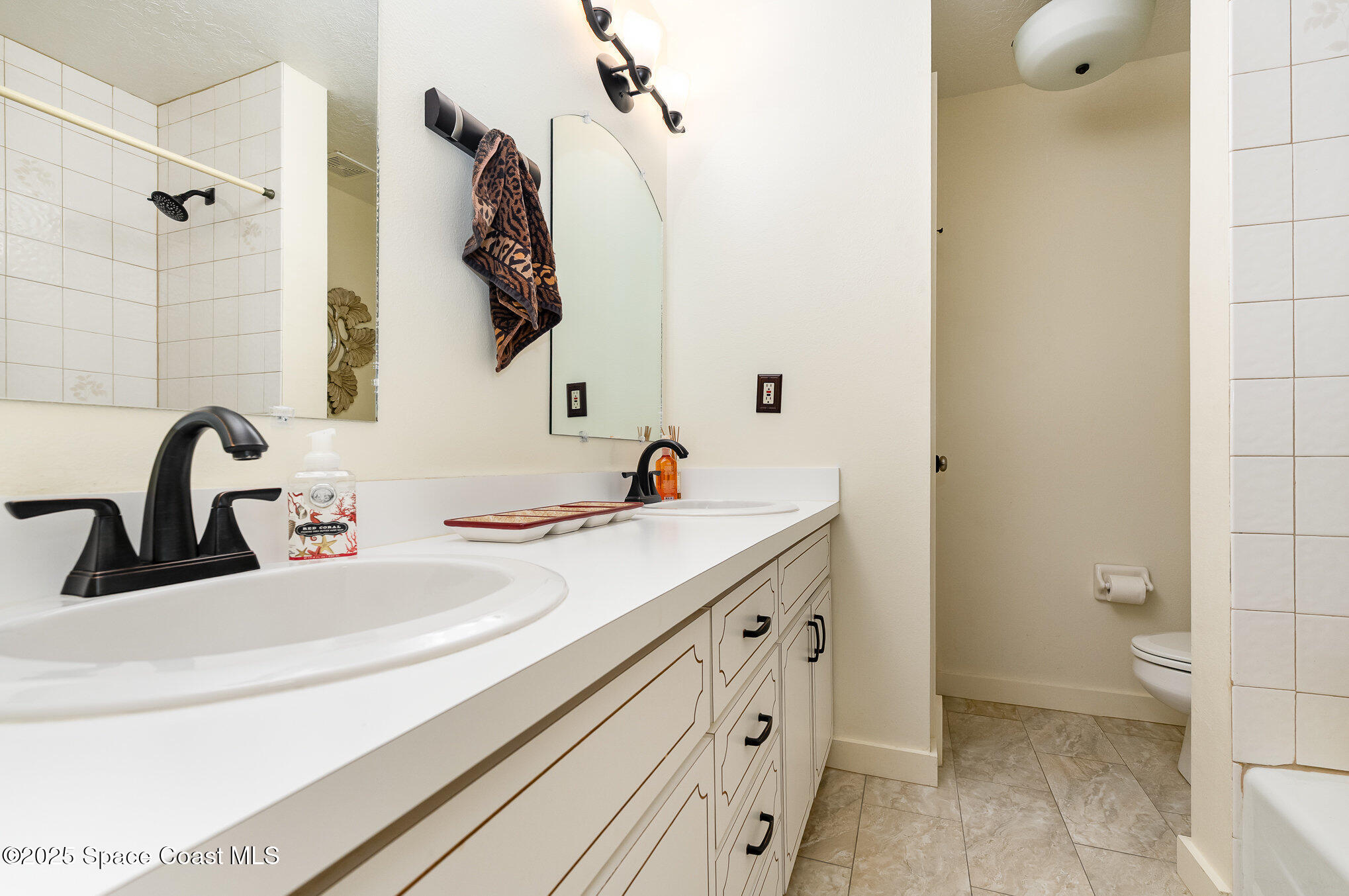 2515 Fairfield Drive Cocoa, FL 32926 - Photo 17 of 31 a bathroom with a sink and a mirror