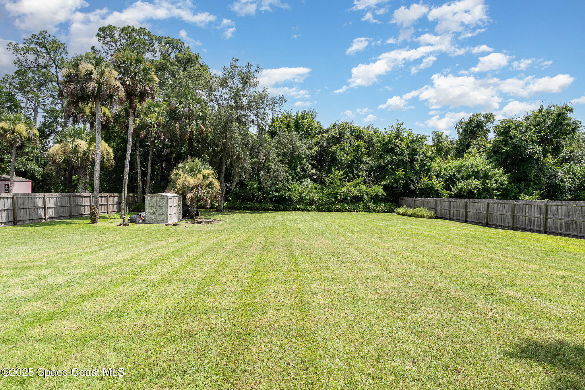 2515 Fairfield Drive Cocoa, FL 32926 - Photo 21 of 31 a swimming pool with wooden fence