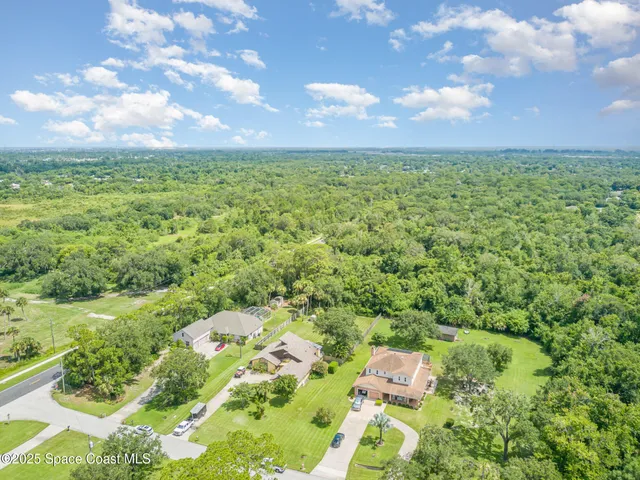 a aerial view of a houses with yard