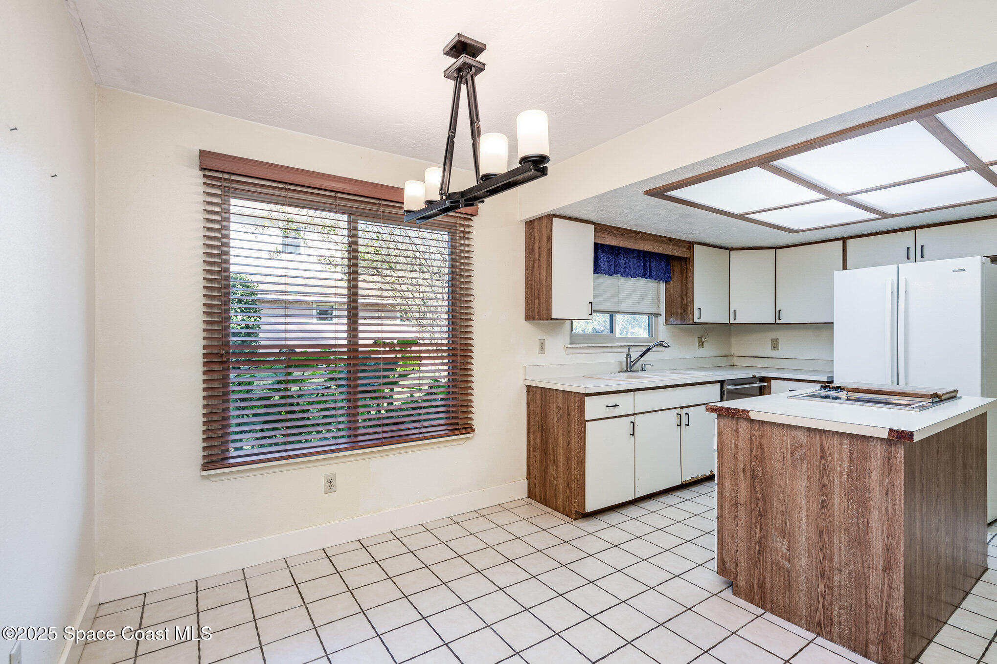 2515 Fairfield Drive Cocoa, FL 32926 - Photo 7 of 31 a kitchen with a stove a sink and cabinets