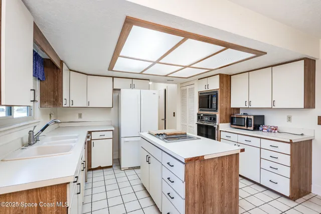 a kitchen with a stove a sink and a refrigerator