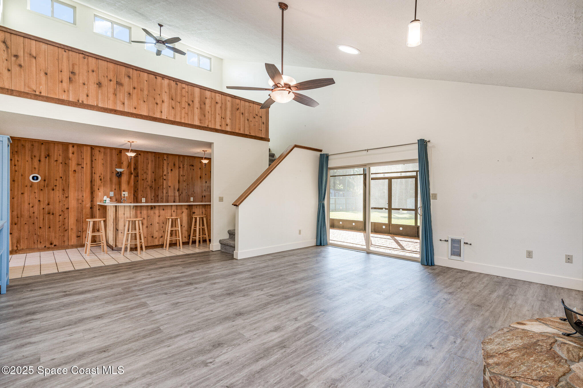 2515 Fairfield Drive Cocoa, FL 32926 - Photo 9 of 31 a view of an empty room with wooden floor and a window
