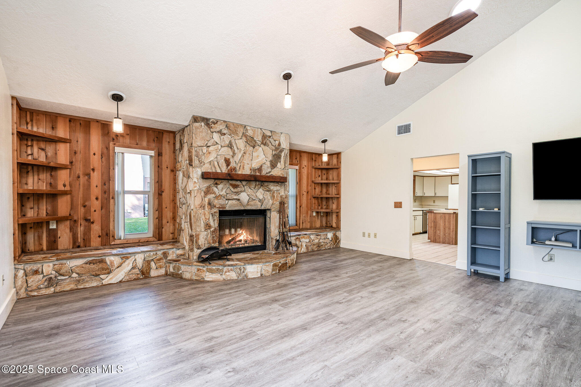 2515 Fairfield Drive Cocoa, FL 32926 - Photo 10 of 31 a living room with furniture a fireplace and a flat screen tv