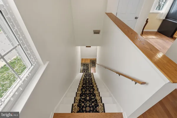 a view of entryway with furniture and wooden floor