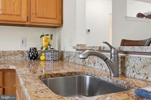 a kitchen with a sink a stove and cabinets