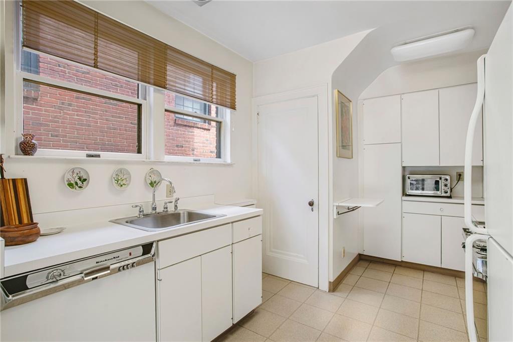 1232 Murdoch Road Pittsburgh, PA 15217 - Photo 14 of 38 a kitchen with a sink cabinets and stove