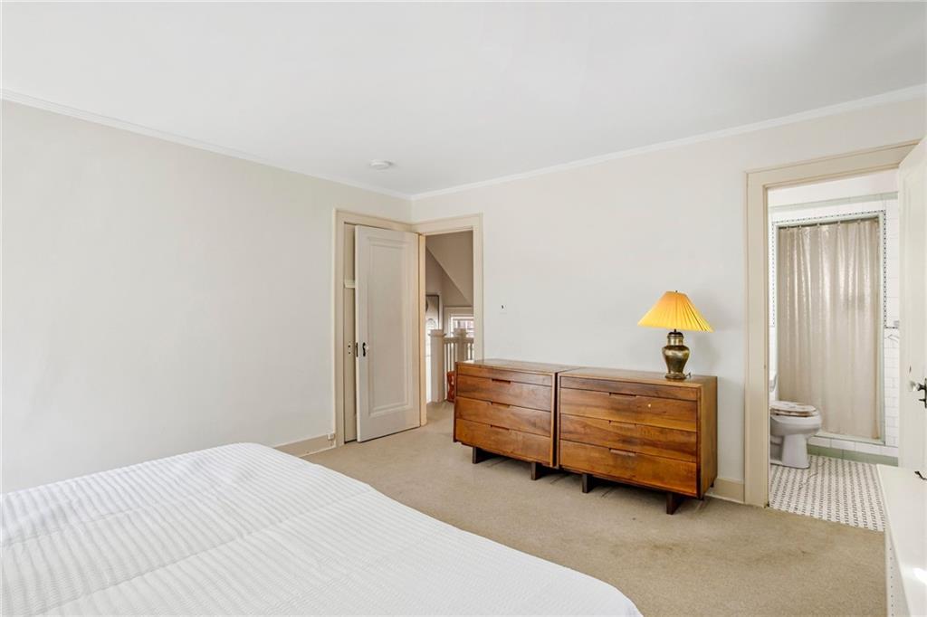 1232 Murdoch Road Pittsburgh, PA 15217 - Photo 17 of 38 a bedroom with a bed and a lamp on dresser