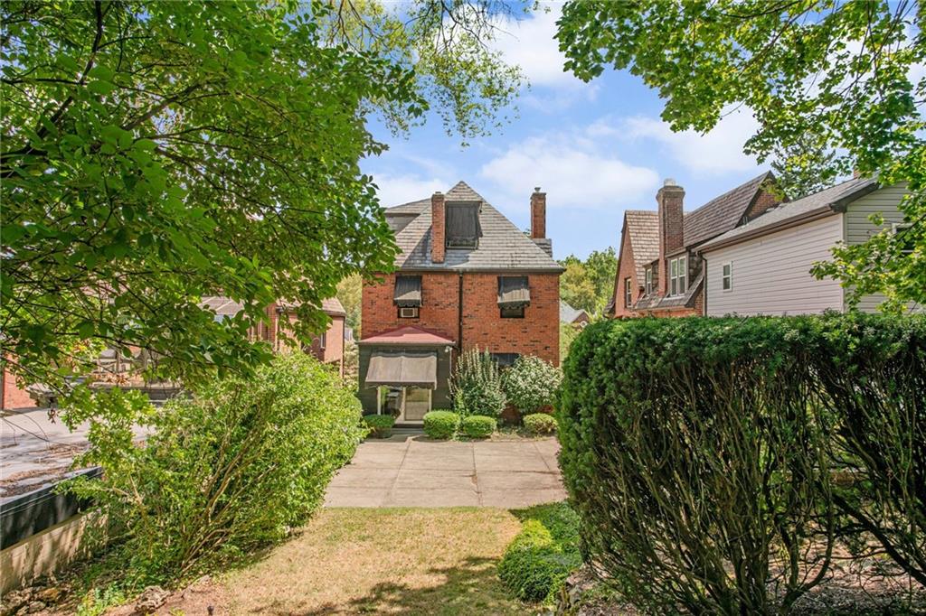 1232 Murdoch Road Pittsburgh, PA 15217 - Photo 30 of 38 a front view of a house with a yard and trees