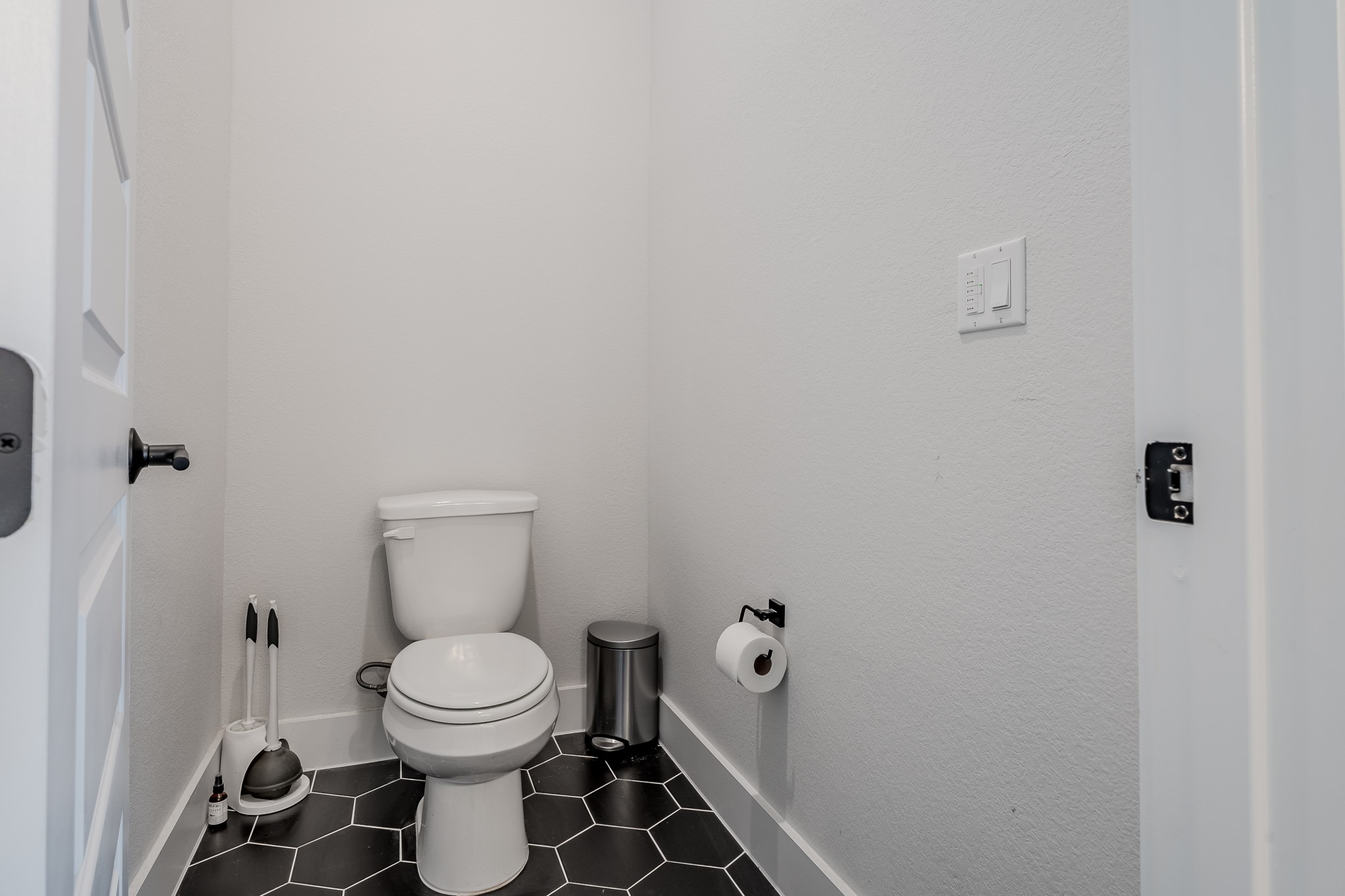 8109 Edmondson Bend Austin, TX 78744 - Photo 17 of 38 A compact, well-maintained powder room features striking hexagon tile flooring.