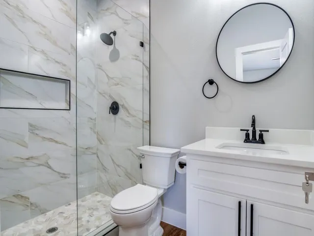a bathroom with a sink toilet and shower