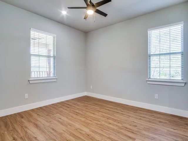 wooden floor in an empty room with a window