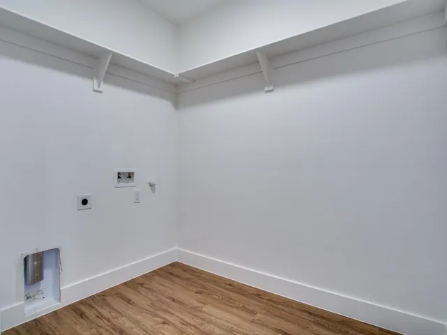 a view of a room with wooden floor