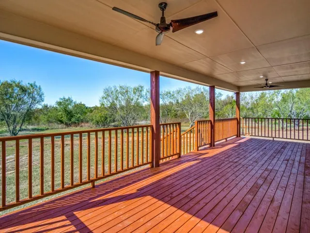 a view of a balcony with wooden floor