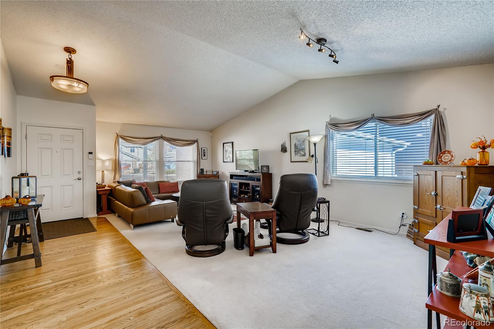 1376 Northridge Road Highlands Ranch, CO 80126 - Photo 3 of 28 a living room with furniture a lamp and a window
